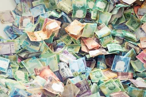 Close up vibrant pile of Qatari Riyal banknotes from the fifth series. Vari.. Stock Photos