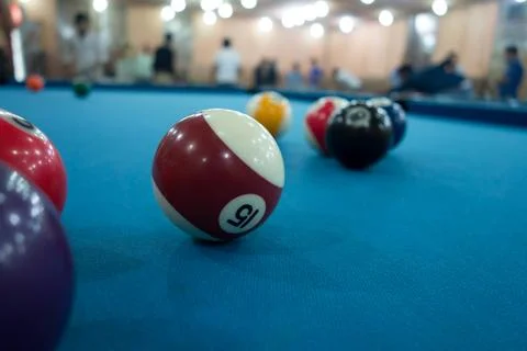 Close-up of vibrant pool balls on a blue felt table in a lively game setting Stock Photos