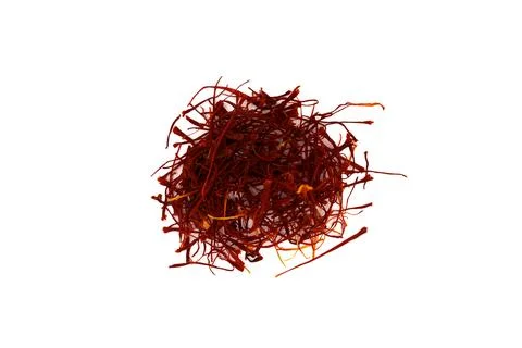 Close-up of vibrant red saffron threads spilling on white background for Stock Photos