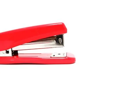 Close-up of a vibrant red stapler on a clean white surface, perfect for off.. Stock Photos