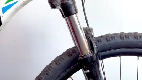 Close-up video of a black bicycle shock absorber compressing and rebounding.. Stock Footage 310256091