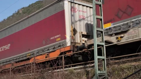 Close-up video of a cargo train carries containers Stock Footage