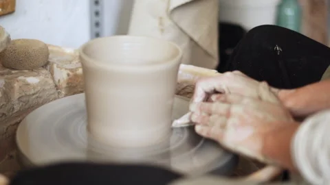 Close-up video of a ceramist using a sharp tool to define the base of a spi.. Stock Footage 272839632