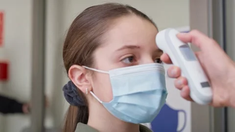 Close up video of checks temperature of students at school. Stock Footage 153532205