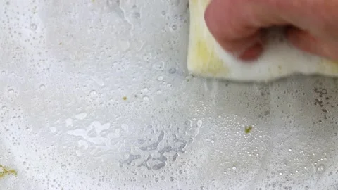 Close video of cleaning a pan with a mesh sponge Stock Footage 142714063
