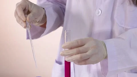 Close up video clip of scientist or medical professional in lab coat and gl.. Video stock 332593040