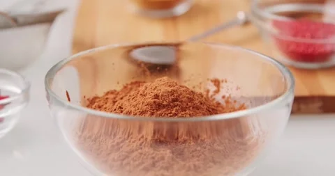 A close-up video of cocoa powder being used for dough flavoring Stock Footage 322070203