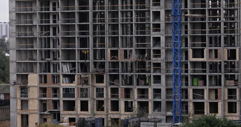 Close Up Video of Construction Crane Lowering Concrete Bucket on Highrise B.. Stock Footage 322774518