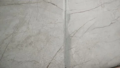 Close up video of a corner seam with grout on a marble effect ceramic tile wall Stock Footage 346720173