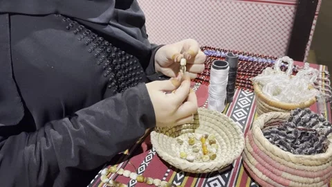 A close-up video of the craft of assembling a rosary. Stock Footage 329453079