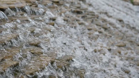 Close up video of crystal clear water running in mountain forest creek. Stock Footage 129655593