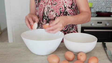 Close-up video eggs being whisked in deep white bowl while making apple cake, ho Video stock 321770880