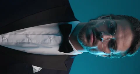Close up video of elegant young man unbuttoning and adjusting tuxedo and Stock Footage 251465208