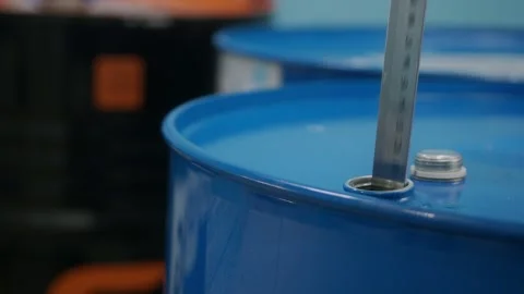 Close-up video. Engine oil is dripping from the metal measuring ruler. Stock Footage 281140004