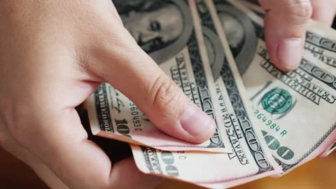 Close up video footage of person's hands counting pile of 100 and 50 dollar.. Stock Footage 334509230