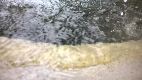 Close-up video of glittering raindrops from large reservoir, with water. Stock Footage 168156942
