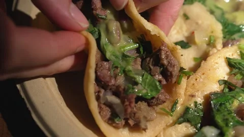 Close up video of hand grabbing carne asada taco Stock Footage 250357846