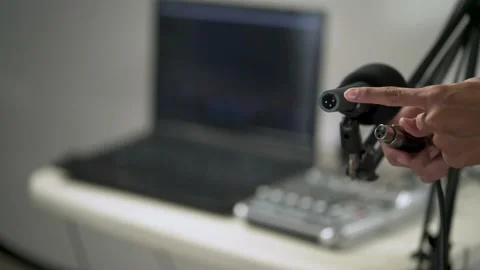 Close up video of hand plugging cable into microphone Video stock 156028487