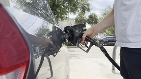 Close up video of a hand refueling a car with a gas pump nozzle Stock Footage 343667785