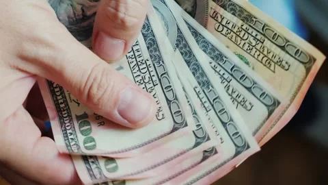 Close up video of hands counting money, displaying an array of fifty and on.. Stock Footage 334844400