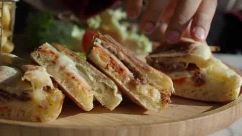 Close up video of hands picking up and showing delicious panini with cheese.. 스톡 동영상 332907614