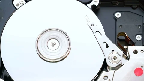 Close up video of a hard disc drive starting, running and stopping Stock Footage 80125281