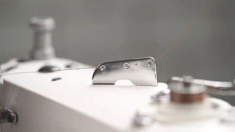 A close-up video of a high quality sewing machine in work. Textile manufacturing Stock Footage 105490514