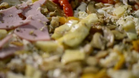 A close-up video of a homemade rectangular pizza topped with ham, artichoke.. 動画素材 302236547