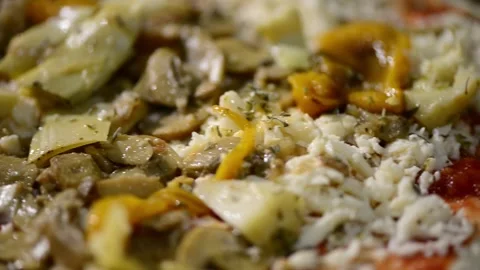 A close-up video of a homemade rectangular pizza topped with ham, artichoke.. 動画素材 302236566