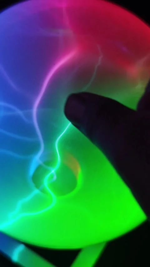 Close up video of a human finger touching a colorful glowing plasma ball. Stock Footage 345289622