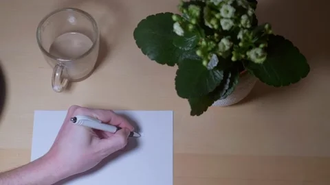 Close-up video of a human hand drawing sketches on paper on a worktable Stock-Footage 170594204