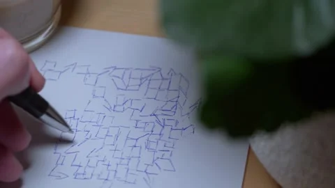 Close-up video of a human hand drawing sketches on paper on a worktable Stock-Footage 170594272
