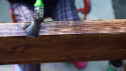Close up video of human hand paints an old wooden board with green paint Stock Footage 151108435