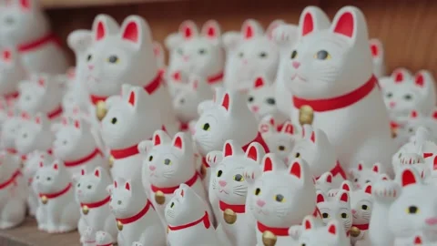 Close-up video of hundreds of iconic Maneki Neko lucky cat statues at Gotokuji Stock Footage 342285258