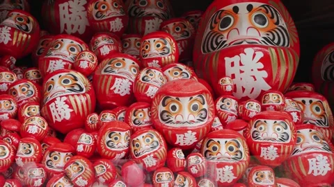 A close-up video of hundreds of red Daruma dolls displayed at Katsuoji Temple Stock Footage 344280203
