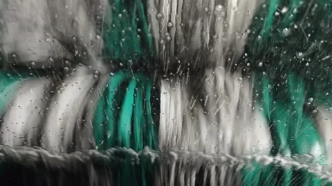 Close up video from inside a car windshield during an automatic car wash. Video stock 340161165