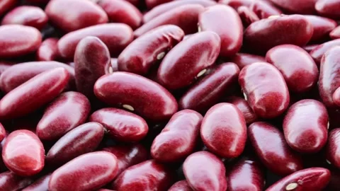 Close-up video of large, shiny red beans moving slowly, highlighting their vibra Stock Footage 343698979