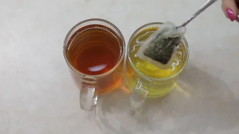 Close video of making a cup of green tea with a fresh tea bag in hot water Stock Footage 105029498