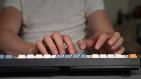 Close-up video of male hands typing quickly on modern mechanical keyboard. Man 動画素材 342758482