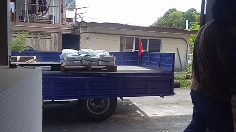 Close-up Video of Male Workers Loading Cement Into Truck From Inside Warehouse Stock Footage 305771467