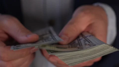 Close up video of man counting dollar banknotes with sun lights, money Stock Footage 287198016