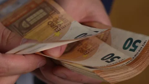 Close up video of man counting dollar banknotes with sun lights, money Stock Footage 287198343