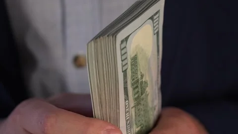 Close up video of man counting dollar banknotes with sun lights, money Stock Footage 287198381