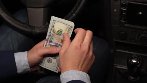 Close up video of man counting dollar banknotes sitting in car, money Stock Footage 304578486