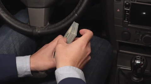 Close up video of man counting dollar banknotes sitting in car, money Stock Footage 307673029