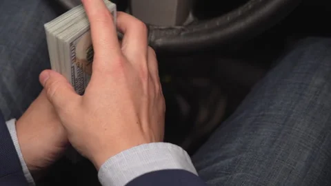 Close up video of man counting dollar banknotes sitting in car, money Stock Footage 320908579