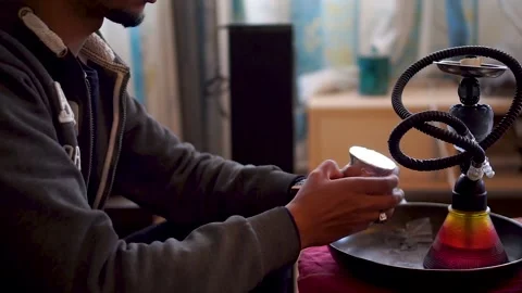 A close up video of a man lonely preparing hookah for vaping shisha Stock Footage 146441555