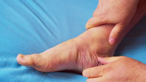 Close-up video of a man massaging his foot 스톡 동영상 335682532