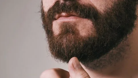 Close up video of man touching his beard and thinking Stock Footage 205562557