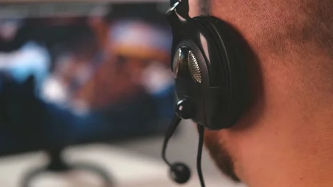 Close up video of man wearing headset with microphone and playing online games Stock Footage 171180576